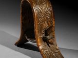 a close up of a wooden object with carvings on it