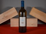 a bottle of wine sitting on a table next to two wooden boxes