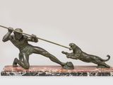 une image représentant une statue d'un homme tenant une lance et accompagné d'un chien
