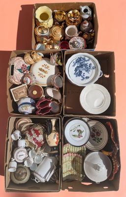 a box full of assorted items sitting on a pink surface