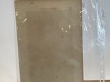 two pieces of clear plastic sitting on top of a wooden shelf