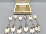 a lot of silver spoons and spoon spoons in a box