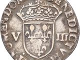 a silver coin with a crown on top of it