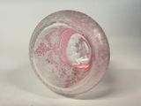a pink glass object with a picture of a woman inside of it