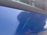 a cat that is sitting on the side of a car