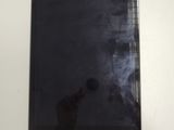 a black tablet computer sitting on a white table