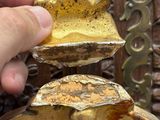 a person holding a piece of gold in their hand