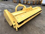 a close up of a large yellow plow sitting on top of a dirt field