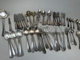 a lot of silver spoons and spoons on the table