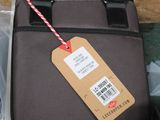 a luggage bag with a tag on it sitting on a table