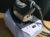 a steam iron sitting on top of a wooden table