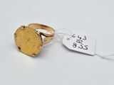 a close up of a gold coin ring with a price tag on it