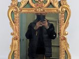 a man taking a picture of himself in a mirror