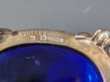 a close up of a blue glass vase on a table