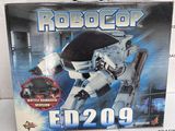toy box of a robot with a gun in it on a white surface
