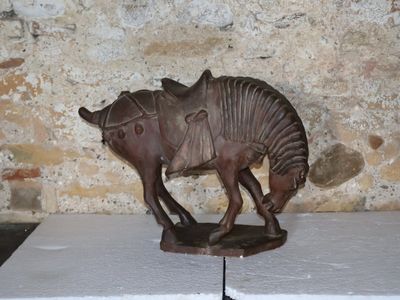 a statue of a horse with a saddle on it ' s back