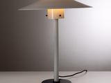 un gros plan d'une lampe de table posée sur une surface blanche