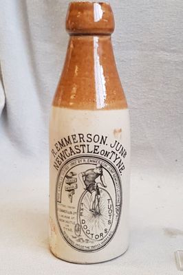 a brown and white bottle sitting on a white table