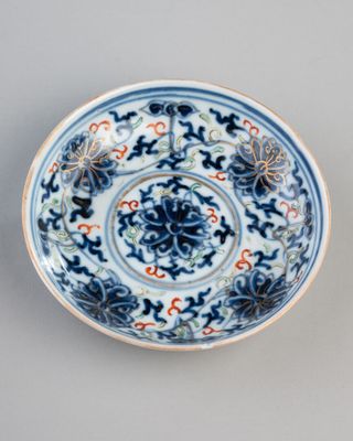 blue and white plate with floral designs on it on a gray surface