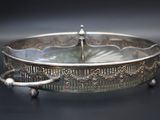 a silver tray with a handle on a black table