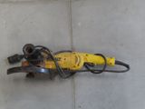 a yellow and black electric drill on the floor