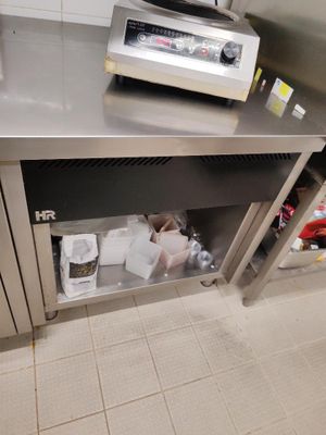 plan de travail en acier inoxydable dans une cuisine professionnelle, avec un grille-pain et d'autres appareils