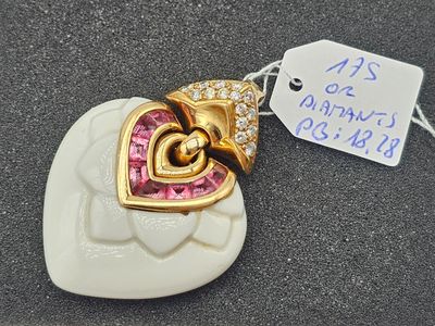 pink and white heart shaped pendant with a tag attached to it