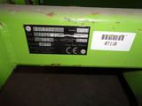 a close up of a green machine with a barcode on it