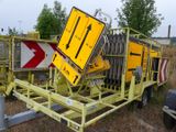 a yellow sign that is sitting on top of a trailer