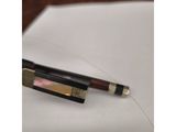 a pen sitting on top of a piece of paper next to a piece of paper