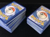 several pokemon cards stacked on top of each other on a black surface