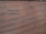 a wooden box with writing on it sitting on a table
