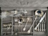 a box with silverware in it and a knife, fork, spoon, and spoon rest