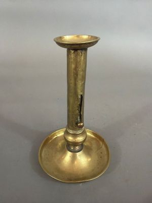 a gold plated candle holder on a white background