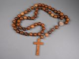 a close up of a wooden rosary with a cross on it