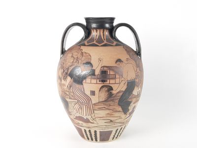 a vase with a painting on it sitting on a table