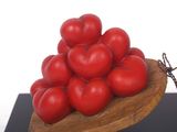 a wooden plate with a bunch of tomatoes on top of it