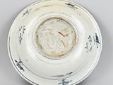 bowl with black and white decoration on it on a gray surface