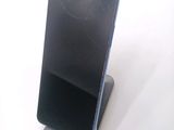a broken cell phone sitting on a stand on a table
