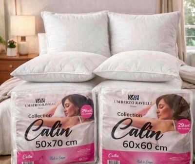 two pillows on top of a bed in a bedroom next to each other