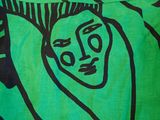 a green pillow with a black and white drawing on it