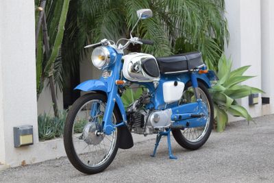 a blue motorcycle parked on the side of the road