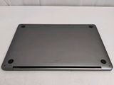 a silver laptop sitting on a white surface