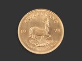 a close up of a gold coin on a black background