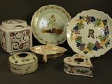 many different types of decorative plates and bowls on the table