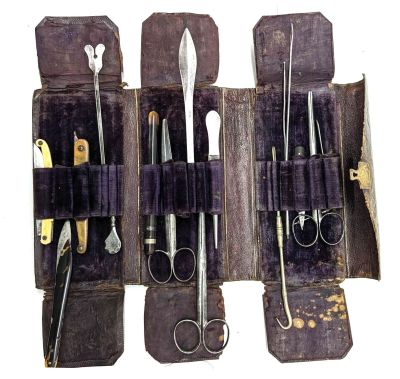 several pairs of scissors are in a case with a pair of scissors in it