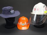 two hats and a hard hat are sitting next to each other