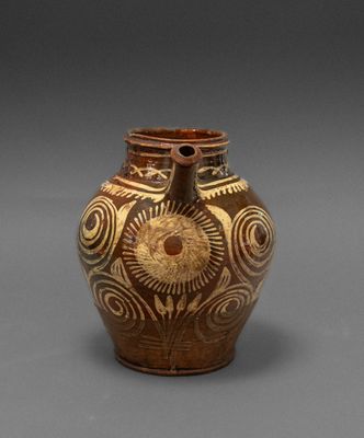 an image of a brown vase with designs on it