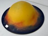 a yellow and orange cake sitting on top of a white stove