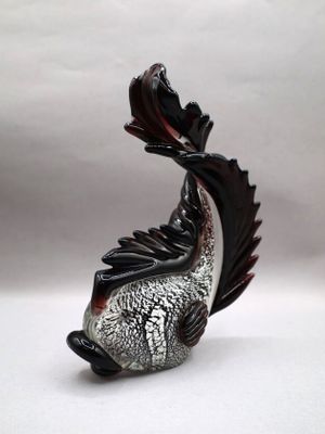 a figurine of a fish that is sitting on a table